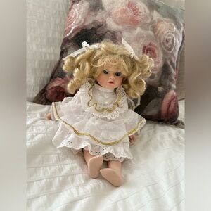 Victorian style porcelain doll with curly blond hair